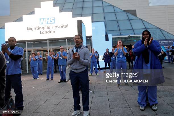 Medical staff and workers take part in a national "clap for carers" to show thanks for the work of Britain's NHS workers and other frontline medical...