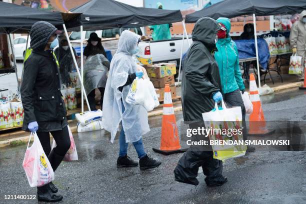 Volunteers organized by the First Baptist Church of Glenarden hand out food to those in need at Suitland High School April 30 in District Heights,...