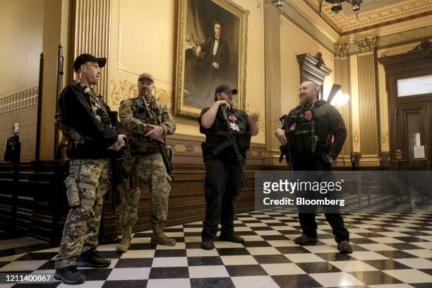 Armed protesters gather at the Michigan Capitol Building in Lansing, Michigan, U.S., on Thursday, April 30, 2020. Protesters demanded that the state...
