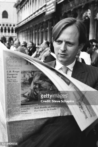 View of American author Tom Wolfe as he reads a newspaper as he attends the 33rd Venice Biennale, Venice, Italy , 1966.