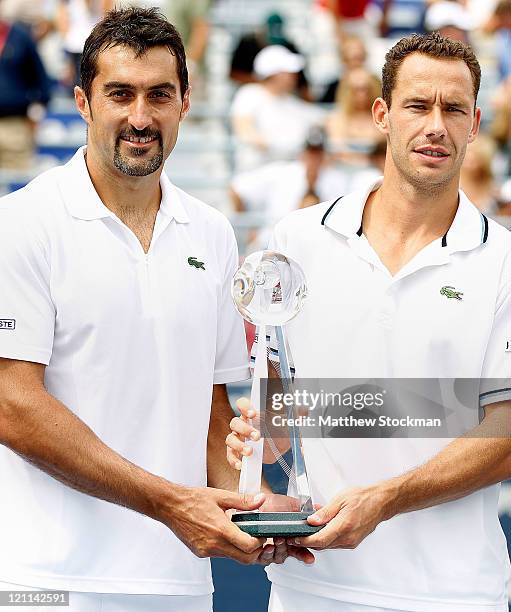 Nenad Zimonjic of Serbia and Michael Llodra of France pose for photographers after defeating the Bryan Brothers in the doubles final during the...