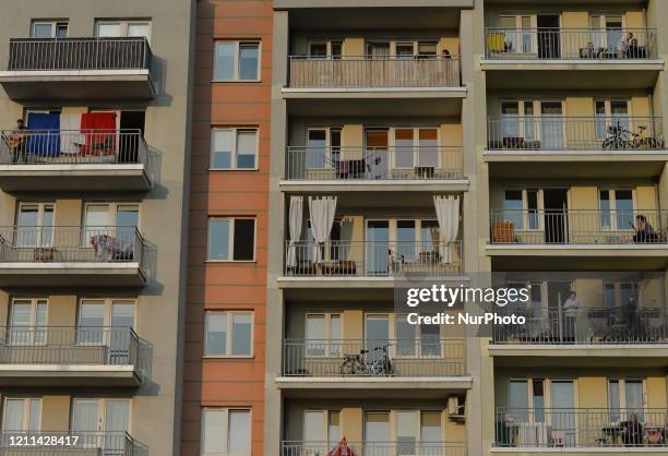 Neighbours listen to Francois Martineau, singing French songs and playing the guitar on his balcony. Francois, a young French musician living in...