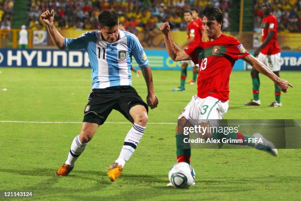 Luis Martins of Portugal is challenged by Juan Iturbe of Argentina during the FIFA U-20 World Cup 2011 quarter final match between Portugal and...