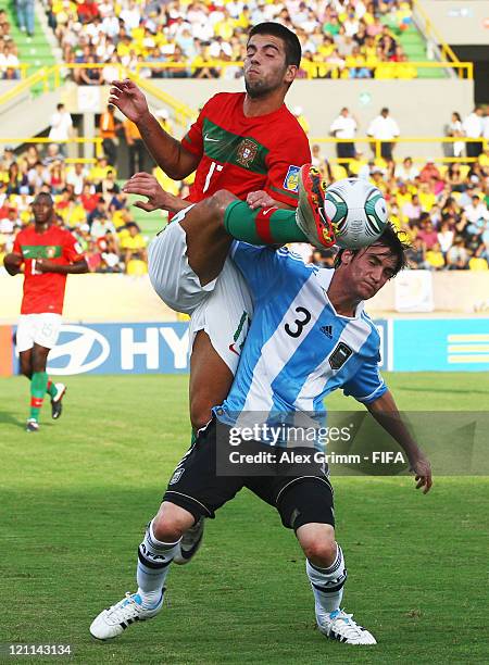 Sergio Oliveira of Portugal is challenged by Nicolas Tagliafico of Argentina during the FIFA U-20 World Cup 2011 quarter final match between Portugal...
