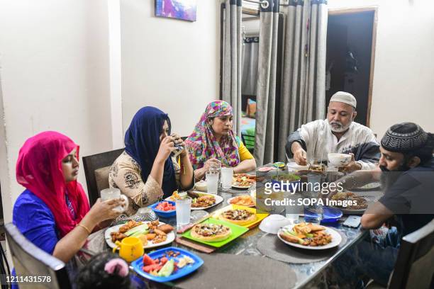 Family having fast-breaking dinner during Ramadan at their house. Muslims fast from dawn to dusk all over the world marking Ramadan the ninth month...