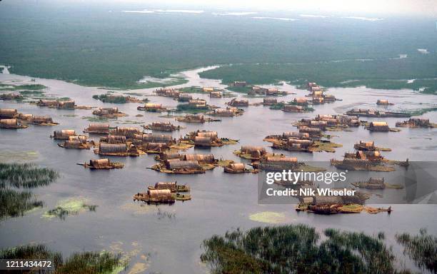 Marsh Arab villages of woven reed houses on small islands dot the landscape where the Tigris and Euphrates Rivers meet at the legendary site of the...