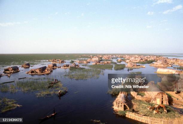 Marsh Arab villages of woven reed houses on small islands dot the landscape where the Tigris and Euphrates Rivers meet at the legendary site of the...