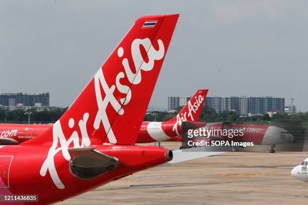 AirAsia aircraft parked at Don Muang International Airport during the Coronavirus crisis. Thai AirAsia and Thai Lion Air resumed flights on domestic...
