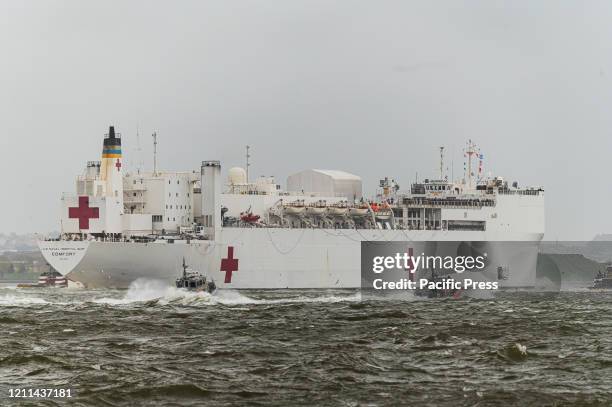 After a month-long stay in New York City, the U.S. Naval hospital ship Comfort is seen traveling on the Hudson River en route to New York Harbor as...