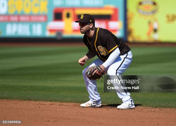 Brian Dozier of the San Diego Padres gets ready to make a play at second base against the Los Angeles Dodgers during a spring training game at Peoria...