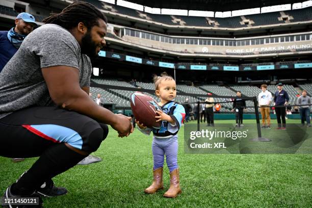 Gelen Robinson of the Dallas Renegades brings his daughter on to the field before the XFL game against the New York Guardians at Globe Life Park on...