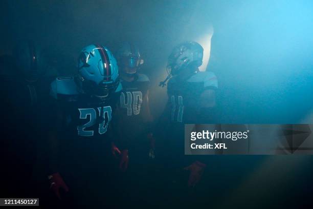 Tenny Adewusi, Tre Watson, and Joshua Crockett of the Dallas Renegades get ready to take the field before the XFL game against the New York Guardians...