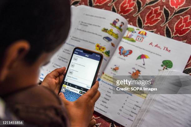 Kashmiri student listen to the lecture of his teacher during an online class via Zoom app as schools remain closed amid the fight against the...