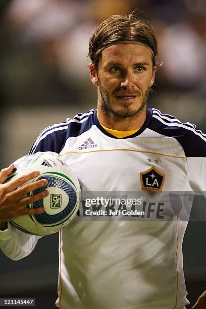 David Beckham of the Los Angeles Galaxy holds the ball before taking a free kick against FC Dallas at The Home Depot Center on August 6, 2011 in...