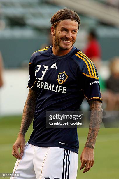David Beckham of the Los Angeles Galaxy smiles as he warms up before the game against FC Dallas at The Home Depot Center on August 6, 2011 in Carson,...
