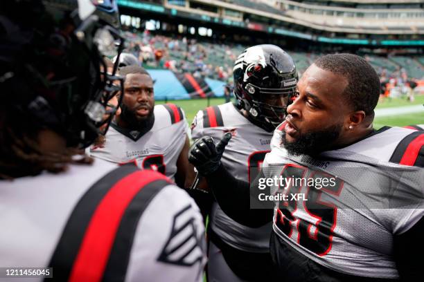 Toby Johnson Jr. #95 of the New York Guardians talks to his teammates before the XFL game against the Dallas Renegades at Globe Life Park on March 7,...