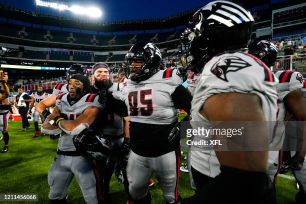 Toby Johnson Jr. #95 of the New York Guardians celebrates with his teammates during the XFL game against the Dallas Renegades at Globe Life Park on...