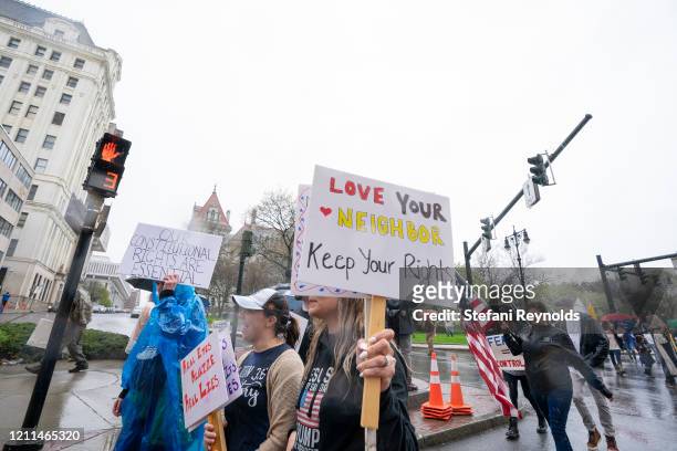 Demonstrators march from the New York State Capitol Building to the Governors Mansion to call for the reopening of New York state on May 1, 2020 in...