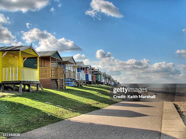 beach huts and promenade at whitstable - whitstable stock pictures, royalty-free photos & images