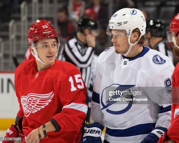 Dmytro Timashov of the Detroit Red Wings looks back at Mikhail Sergachev of the Tampa Bay Lightning during an NHL game at Little Caesars Arena on...