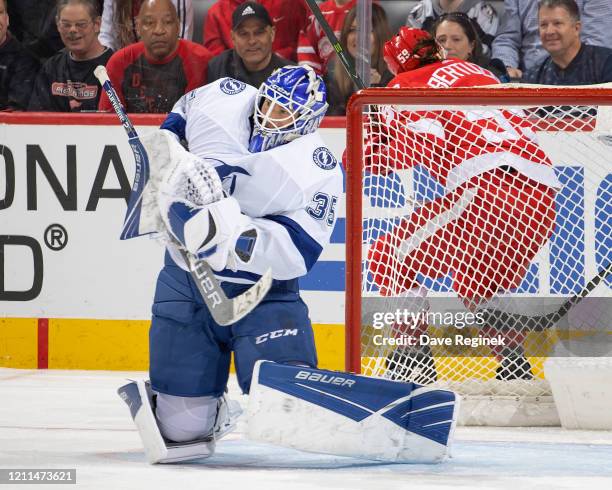 Curtis McElhinney of the Tampa Bay Lightning makes a shoulder save against the Detroit Red Wings during an NHL game at Little Caesars Arena on March...