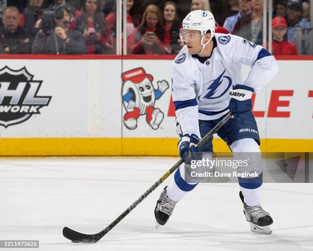 Luke Schenn of the Tampa Bay Lightning controls the puck against the Detroit Red Wings during an NHL game at Little Caesars Arena on March 8, 2020 in...