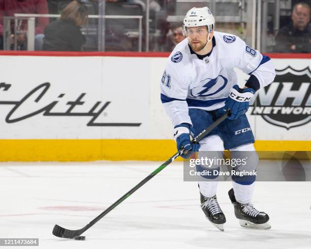 Erik Cernak of the Tampa Bay Lightning skates up ice with the puck against the Detroit Red Wings during an NHL game at Little Caesars Arena on March...