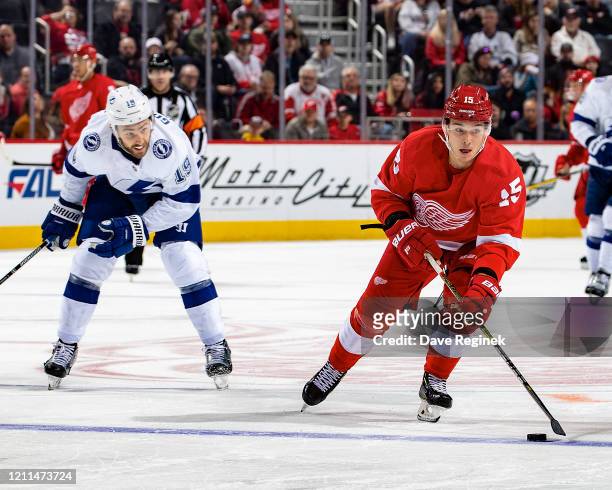 Dmytro Timashov of the Detroit Red Wings skates up ice with the puck next to Barclay Goodrow of the Tampa Bay Lightning during an NHL game at Little...