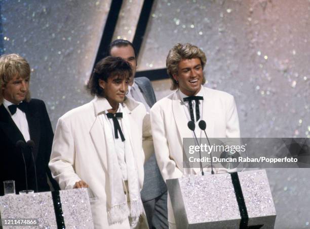 George Michael and Andrew Ridgeley of the pop duo Wham! accepting the award for Best British Group at the Brit Awards at the Grosvenor House Hotel in...