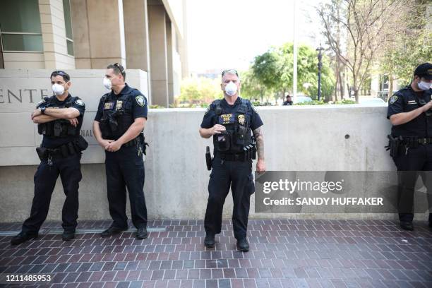 Police officers watch while demonstrators protest during a rally to re-open California and against Stay-At-Home directives on May 1, 2020 in San...