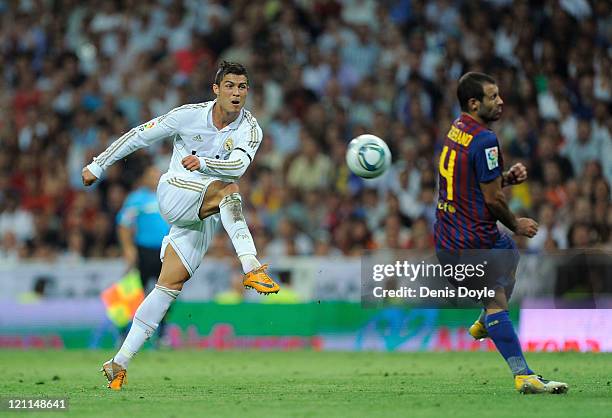 Cristiano Ronaldo of Real Madrid shoots past Javer Mascherano of Barcelona during the Super Cup first leg match between Real Madrid and Barcelona at...