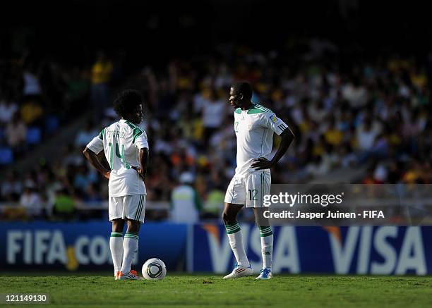 Uche Nwofor and Sani Emmanuel of Nigeria stand dejected waiting to resume the game after France scored during the FIFA U-20 World Cup Colombia 2011...