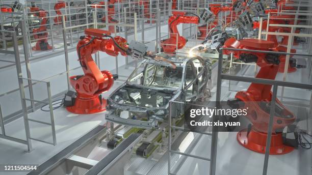 industrial robots welding car body in car factory - automotive industry stock pictures, royalty-free photos & images