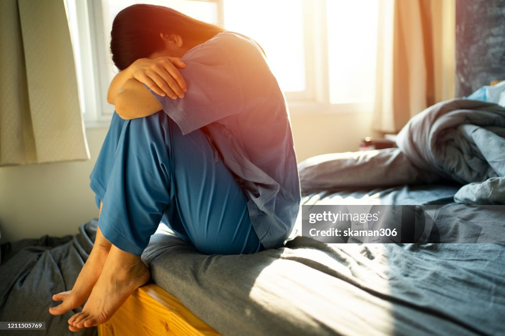 Asian teen female wearing cover eye equipment and Feeling unhappy after Lasik Surgery