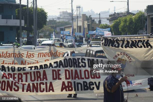 Demonstrators wearing face masks protest on Labour Day against Pension Funds Administrators demanding the refund of their pensions on May 1, 2020 in...