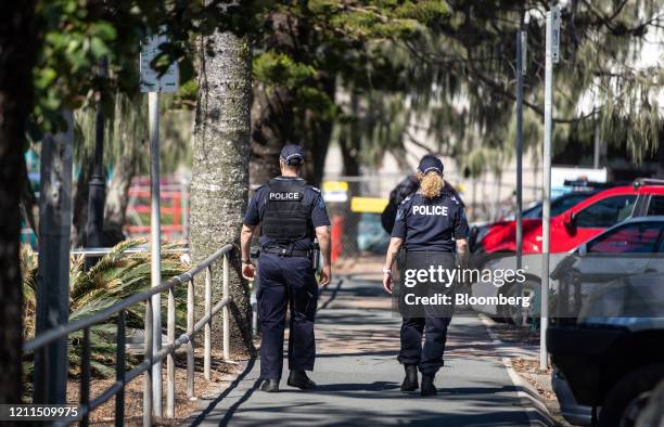 Police officers walk along the esplanade at Mooloolaba Beach in Mooloolaba, Australia, on Saturday, May 2, 2020. Australia's Prime Minister Scott...