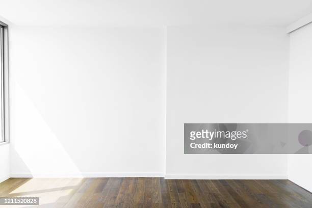 abstract background from blank white concrete wall at home or office with wooden floor. picture for add text message. backdrop for design art work. - home interiors ストックフォトと画像