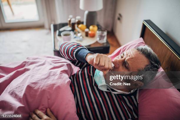 older man sick with covid-19 - mucus stock pictures, royalty-free photos & images