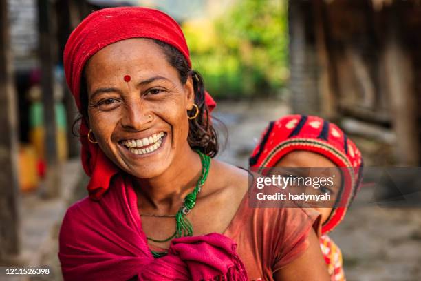 happy nepalese woman carrying her baby near annapurna range - nepal women stock pictures, royalty-free photos & images