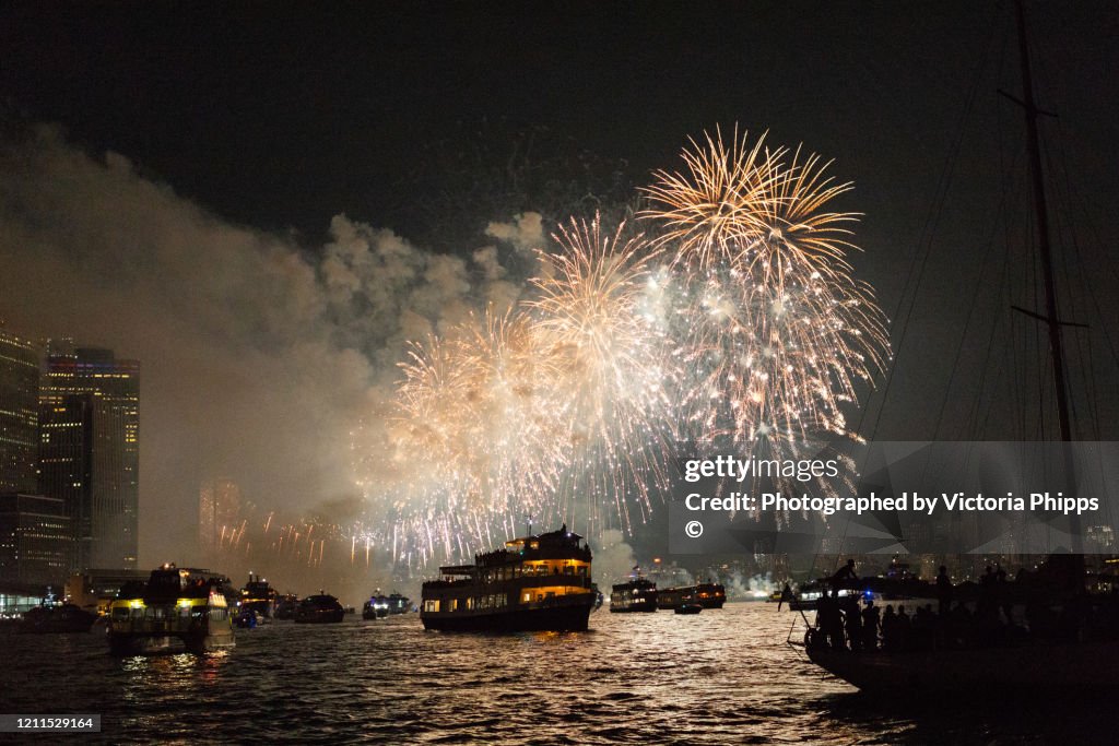 Firework display in New York Bay with boats in the foreground