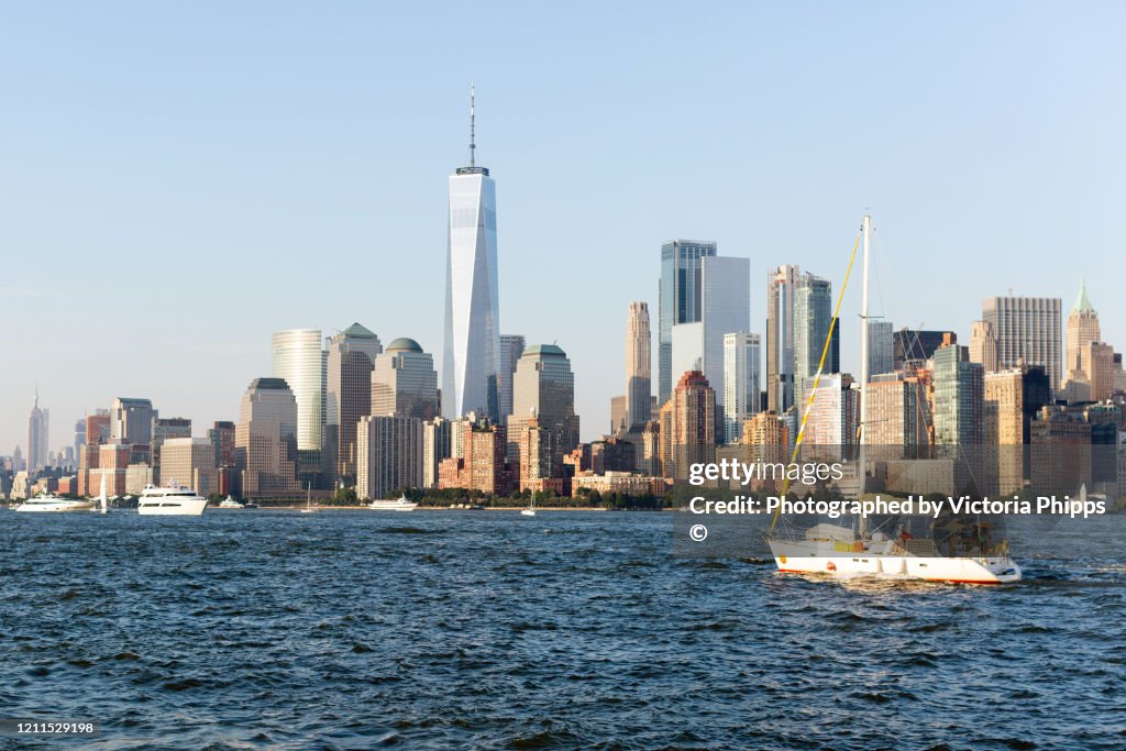 A white sailing boat enters the Hudson River in New York