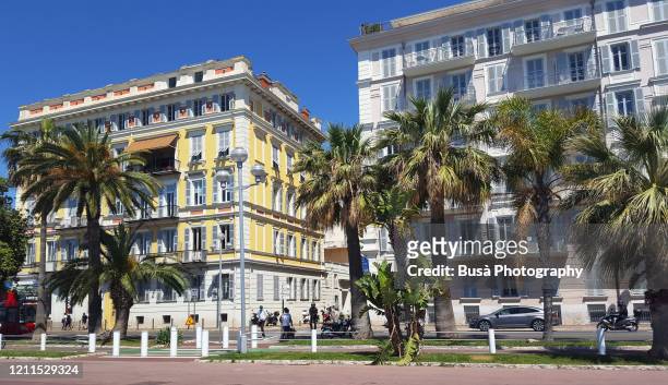 elegant residential buildings along promenade des anglais, nice, french riviera, france - プロムナーデザングレ ストックフォトと画像