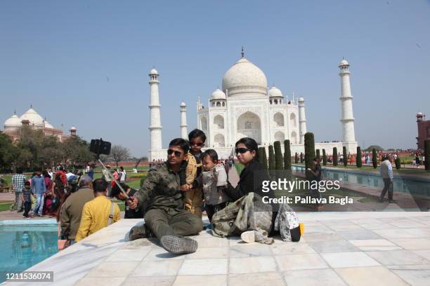 Family take a selfie while visiting the Taj Mahal the world famous on February 29, 2020 in Agra, India.