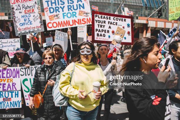 Protester at the Re-Open Illinois gathering outside the Thompson Center in Chicago IL during protest restrictions instituted by the governor to...