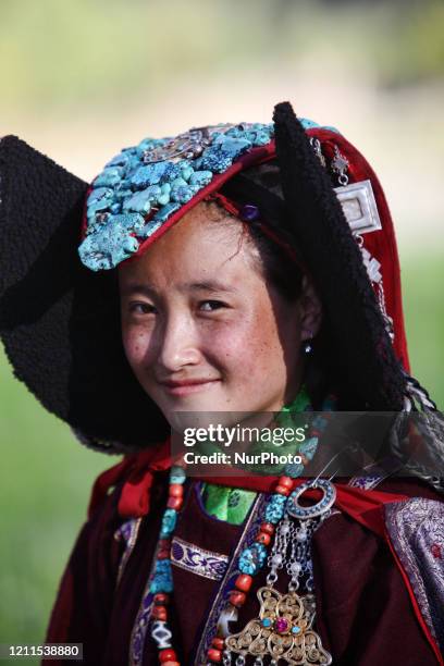 Ladakhi girl wearing in a traditional outfit with a turquoise studded perak headdress in the small village of Tangtse, Ladakh, Jammu and Kashmir,...