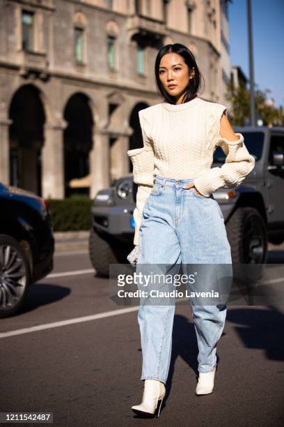 Yoyo Cao, wearing a cream decorated sweater, blue jeans and white heels, is seen outside Philosophy di Lorenzo Serafini show, during Milan Fashion...