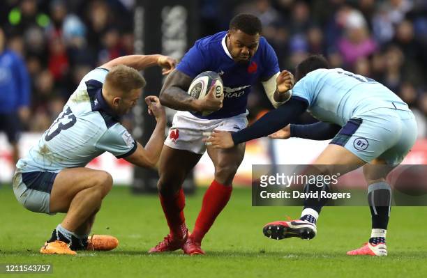 Virimi Vakatawa of France is tackled by Chris Harris and Sam Johnson during the 2020 Guinness Six Nations match between Scotland and France at...