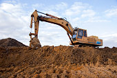 Track-type excavator during earthmoving work at open-pit mining