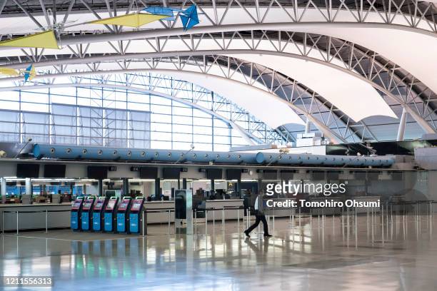 Ground staff member walks through the departure hall at Kansai International Airport on March 10, 2020 in Osaka, Japan. The Japanese government is...