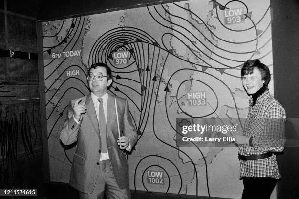 British television weather reporter Ian McCaskill and Mandy Preedy pose in front of the BBC weather map, United Kingdom, 8th January 1985.